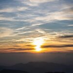 Breathtaking Sunset Over Mountain Range with Wispy Clouds