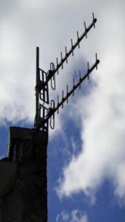 Charming TV Antenna on Chimney with Blue Sky