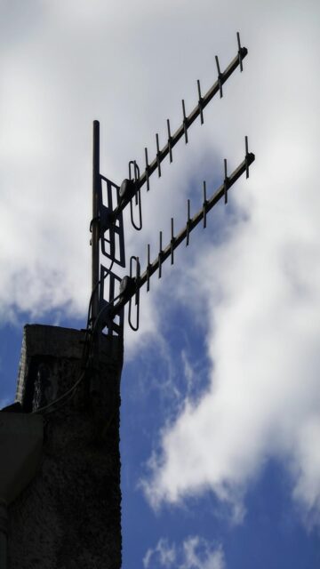Charming TV Antenna on Chimney with Blue Sky