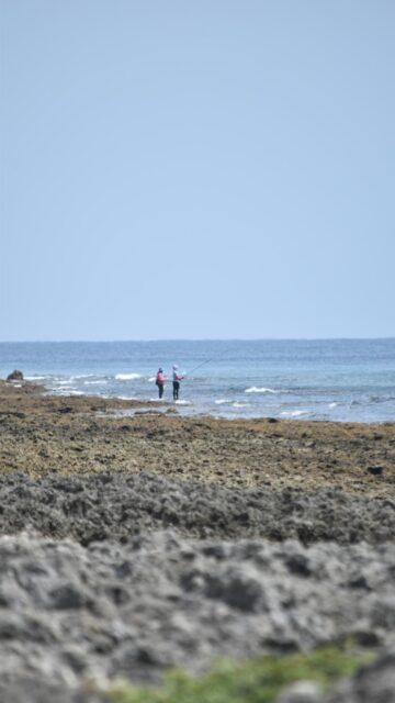 Rocky Ocean View with Two Fishermen