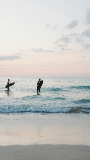 Coastal Vibes: Surfers Riding Waves