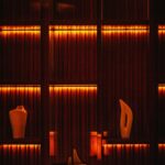 Cozy Warmth: Orange Lights on Shelves with Vases