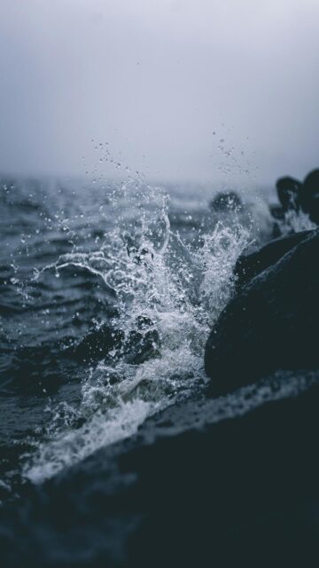 Cloudy Day Waves Against Rocks