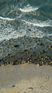 Soothing Ocean Scene: Waves on Rocky Shore onto Sandy Beach