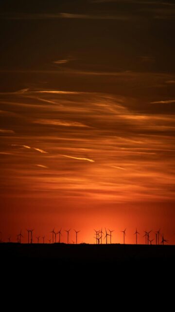 Fiery Sunset Sky with Wind Turbines