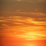 Vibrant Sunset Silhouette of Wind Turbines