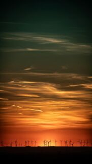 Vibrant Sunset Background With Wind Turbines