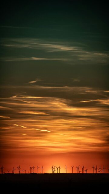 Vibrant Sunset Background With Wind Turbines