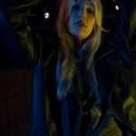 Nightly Vibes - Woman in Leather Jacket Behind Fences