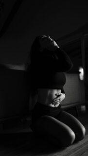 Intimate Moment – Woman Kneeling On Floor Hands On Stomach