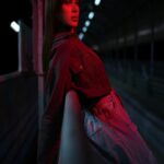 Red Night Scene: Woman Leaning On Railing