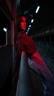 Red Night Scene: Woman Leaning On Railing