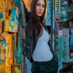 Urban Vibes - Woman Leans Against Graffiti Wall