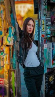 Urban Vibes – Woman Leans Against Graffiti Wall