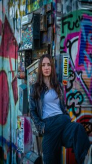 Urban Chic – Woman Posing Against A Graffiti Covered Wall