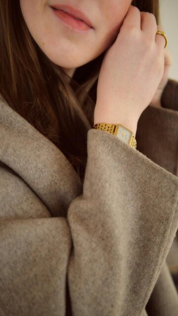Woman in Style: Gold Watch and Coat