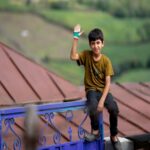 Mazandaran Village Life - Young Boy Waving From Fence