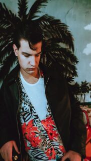 Retro Vibes: Young Man in Tropical Mural Background