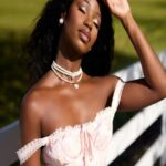Pink Dress Shielding Eyes from Sun