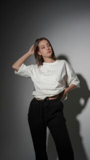Young Woman Posing in White T-Shirt and Black Pants