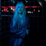 Blonde Woman in Leather Jacket at Night
