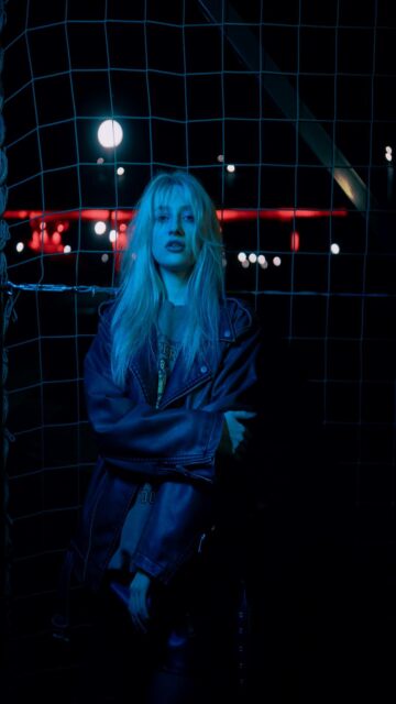 Blonde Woman in Leather Jacket at Night