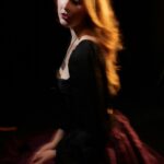 Young Woman With Flowing Hair In A Dark Dress