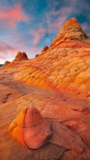 Breathtaking Desert Landscape with Unique Orange Rock Formations and Sunset Sky