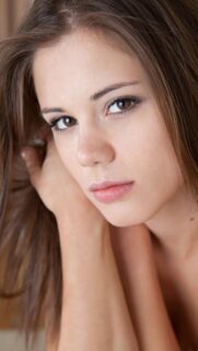 Stunning Portrait of a Young Woman with Brown Eyes and Natural Hair Mobile Wallpaper
