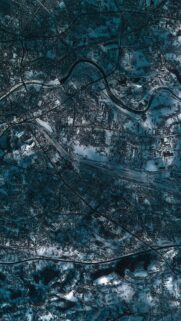 Stunning Aerial View of a Snowy Winter Cityscape at Night Mobile Wallpaper