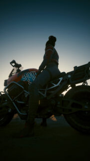 Cyberpunk Rider Silhouette on Motorcycle at Sunset Mobile Wallpaper