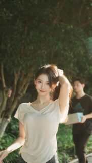 Beautiful Young Asian Woman Smiling in a Park Sunset Mobile Wallpaper