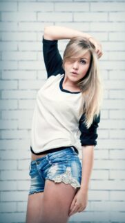 Stunning Portrait of a Blonde Girl in a Baseball Tee and Denim Shorts Wallpaper