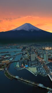 Breathtaking Sunset View of Mount Fuji Overlooking a Modern Japanese Cityscape Wallpaper