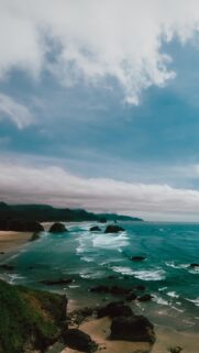 Stunning Pacific Northwest Coastal View with Misty Ocean Waves and Dramatic Cloudy Sky