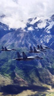 Formation of Military Fighter Jets Over Majestic Snowy Mountains Wallpaper