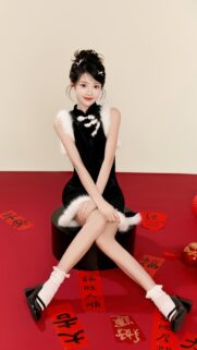 Beautiful Young Asian Woman in Traditional Black Qipao with Fur Trim Wallpaper