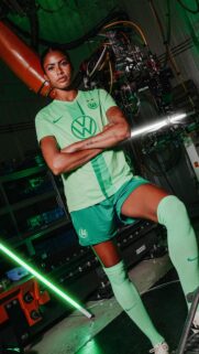 VfL Wolfsburg Female Player Portrait in Industrial Setting Mobile Wallpaper