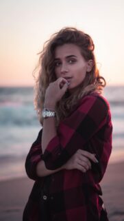 Stunning Portrait of a Woman in a Red Plaid Shirt at Sunset Mobile Wallpaper