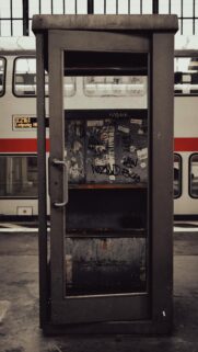 Gritty Urban Phone Booth at Train Station Wallpaper for Mobile