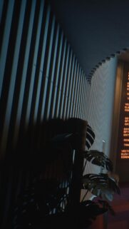 Minimalist Cyberpunk Interior with Glowing Amber Data Display Wallpaper
