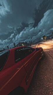 Red Twin Turbo Sports Car on Scenic Night Road Mobile Wallpaper