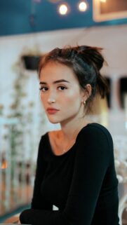 Stunning Portrait of a Young Woman with Natural Beauty and Elegant Style Wallpaper