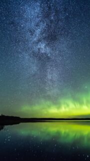 Breathtaking Northern Lights Over Calm Lake Starry Night Mobile Wallpaper