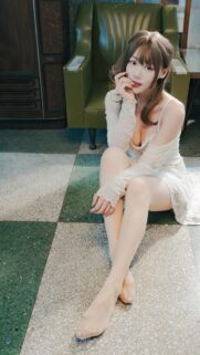 Beautiful Asian Girl in Elegant White Dress Sitting on Retro Tiled Floor Wallpaper