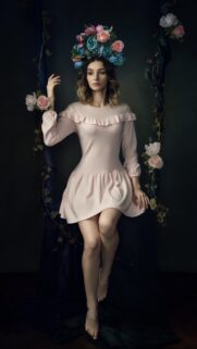 Elegant Young Woman with Floral Crown on Hanging Swing Wallpaper for Mobile