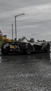 Black BAC Mono Sports Car on Wet Asphalt Road Wallpaper for Mobile