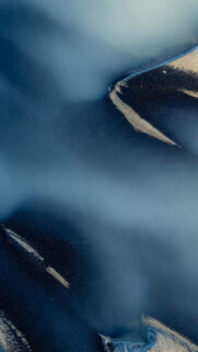 Stunning Aerial View of Misty Mountains and Snowy Ridges Wallpaper