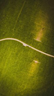 Stunning Aerial View of Soccer Field and Green Park Path Wallpaper