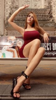 Stunning Fashion Model in Burgundy Dress Sitting on Bench Wallpaper for Mobile